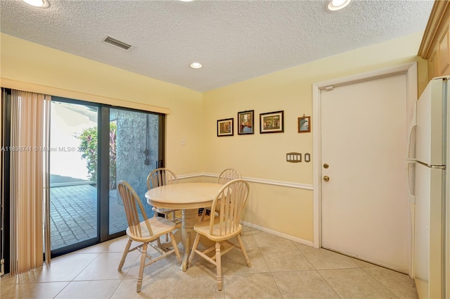 8406 NW 78th Ct, Tamarac, FL 33321 - dining area featuring a textured ceiling, light tile patterned floors, and recessed lighting