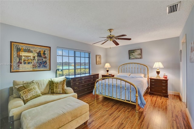 8406 NW 78th Ct, Tamarac, FL 33321 - bedroom with a textured ceiling, wood finished floors, and a ceiling fan