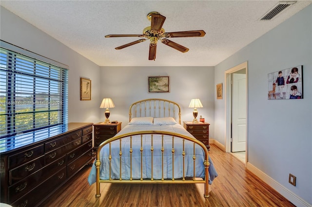 8406 NW 78th Ct, Tamarac, FL 33321 - bedroom featuring wood finished floors, a textured ceiling, and ceiling fan