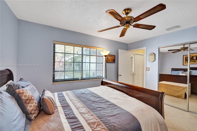 8406 NW 78th Ct, Tamarac, FL 33321 - bedroom with a ceiling fan, light tile patterned floors, a textured ceiling, and a closet