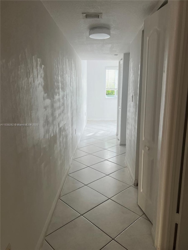 12645 SW 91st St Unit 202, Miami, FL 33186 - corridor with light tile patterned floors and a textured ceiling