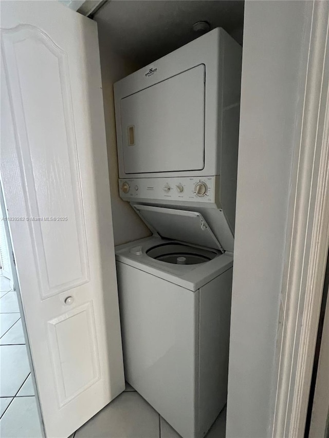 12645 SW 91st St Unit 202, Miami, FL 33186 - laundry room featuring stacked washer / drying machine and light tile patterned floors
