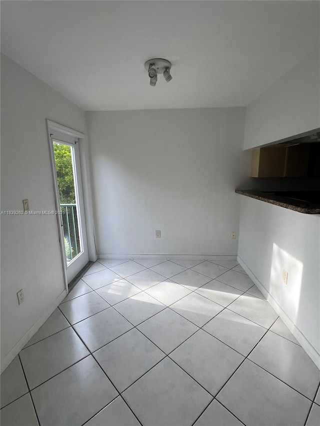 12645 SW 91st St Unit 202, Miami, FL 33186 - unfurnished dining area with light tile patterned flooring and baseboards