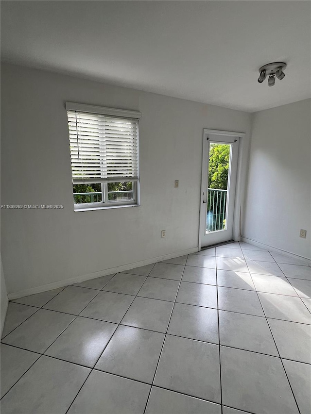 12645 SW 91st St Unit 202, Miami, FL 33186 - spare room featuring light tile patterned flooring and baseboards