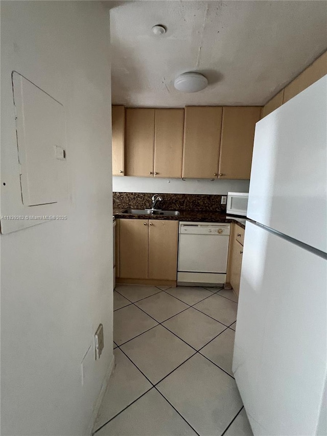 12645 SW 91st St Unit 202, Miami, FL 33186 - kitchen with white appliances, dark countertops, light tile patterned floors, and cream cabinets