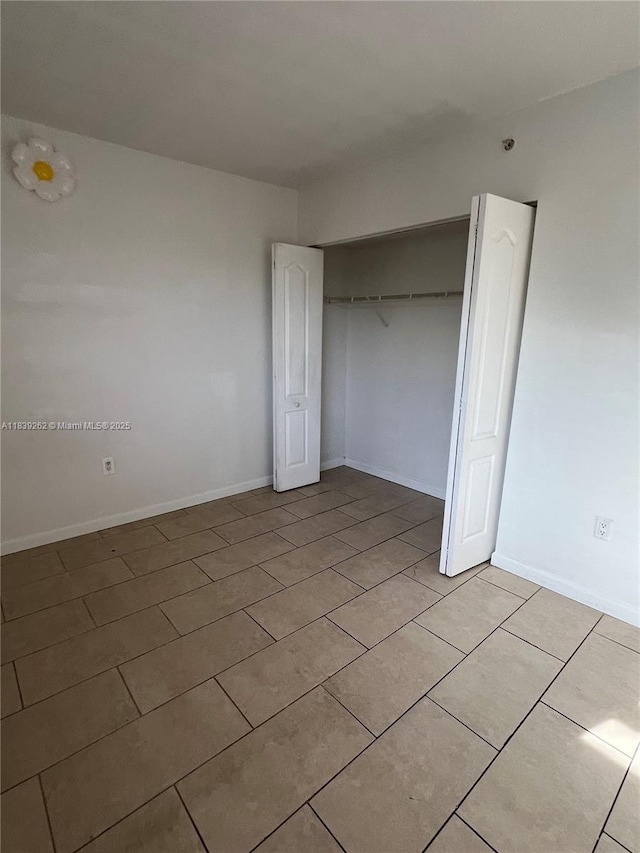 12645 SW 91st St Unit 202, Miami, FL 33186 - unfurnished bedroom featuring light tile patterned flooring and a closet