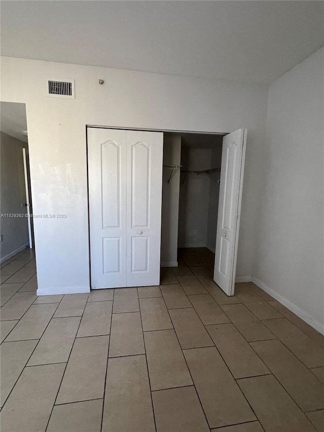 12645 SW 91st St Unit 202, Miami, FL 33186 - unfurnished bedroom featuring light tile patterned flooring and a closet