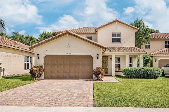 10608 NW 36th St, Coral Springs, FL 33065 - mediterranean / spanish-style home with a tiled roof, decorative driveway, stucco siding, a front lawn, and a garage