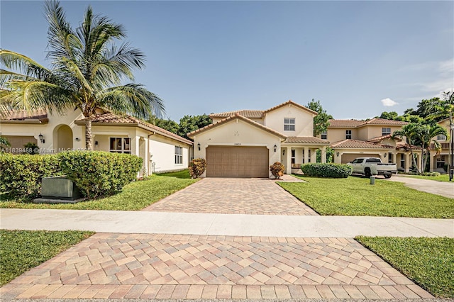 10608 NW 36th St, Coral Springs, FL 33065 - mediterranean / spanish home featuring stucco siding, decorative driveway, a front lawn, a garage, and a tile roof
