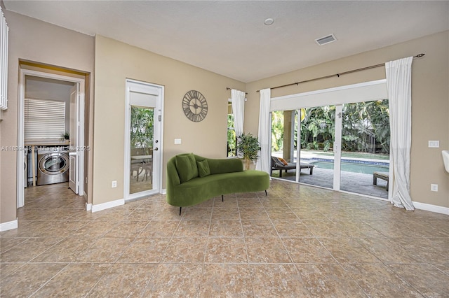 10608 NW 36th St, Coral Springs, FL 33065 - living area featuring healthy amount of natural light, washing machine and clothes dryer, and tile patterned floors