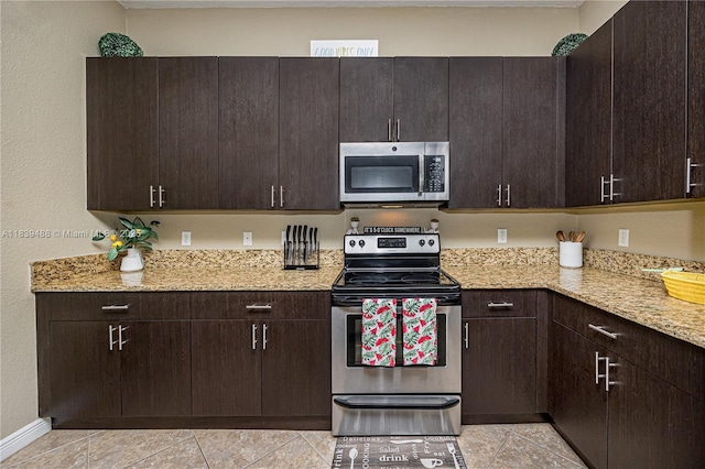 10608 NW 36th St, Coral Springs, FL 33065 - kitchen featuring stainless steel appliances, light tile patterned floors, and dark brown cabinetry