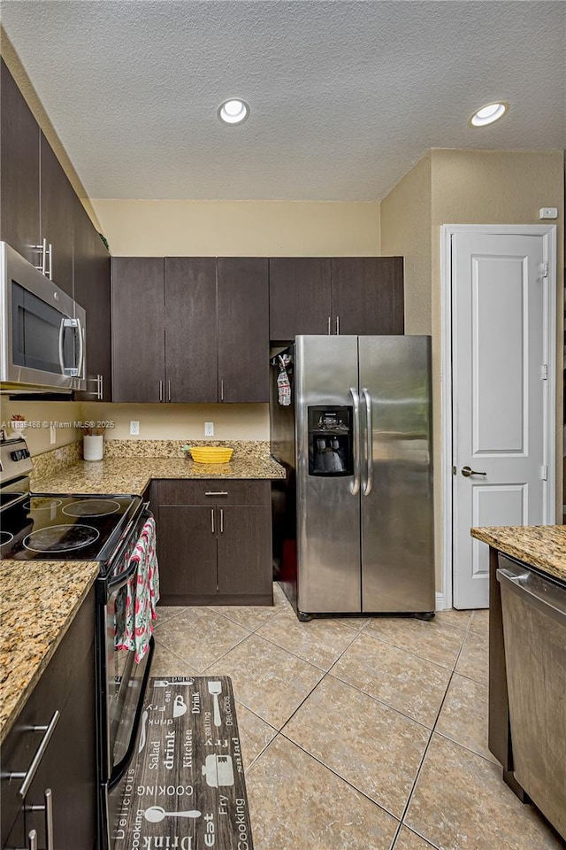 10608 NW 36th St, Coral Springs, FL 33065 - kitchen with appliances with stainless steel finishes, dark brown cabinetry, a textured ceiling, light tile patterned flooring, and recessed lighting