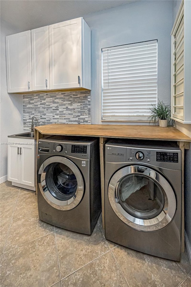 10608 NW 36th St, Coral Springs, FL 33065 - laundry room featuring washer and clothes dryer, light tile patterned floors, and cabinet space