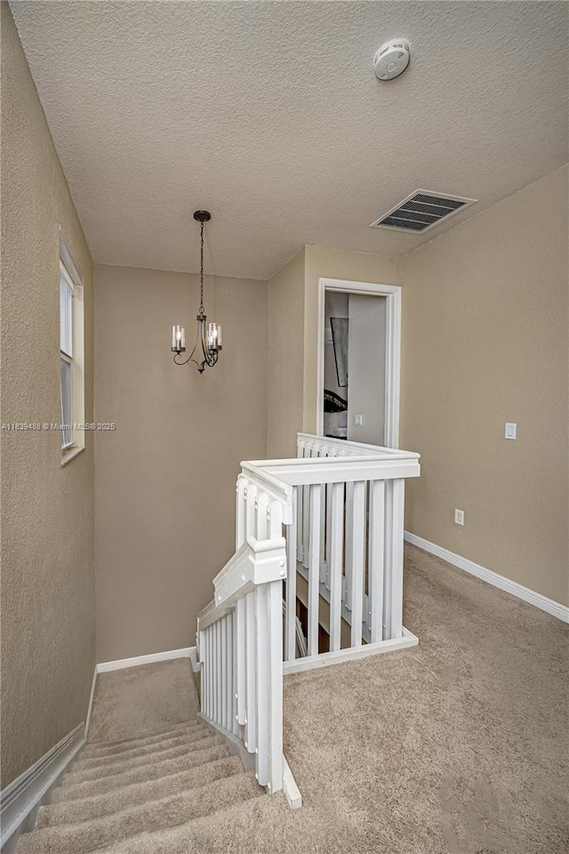 10608 NW 36th St, Coral Springs, FL 33065 - stairs featuring a chandelier, carpet flooring, and a textured ceiling