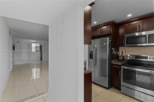 6600 Royal Palm Blvd Unit 103B, Margate, FL 33063 - kitchen with stainless steel appliances, light tile patterned flooring, dark stone countertops, dark brown cabinets, and recessed lighting