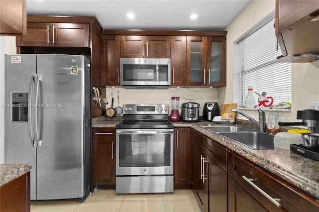 6600 Royal Palm Blvd Unit 103B, Margate, FL 33063 - kitchen featuring appliances with stainless steel finishes, light tile patterned flooring, glass insert cabinets, dark brown cabinetry, and recessed lighting