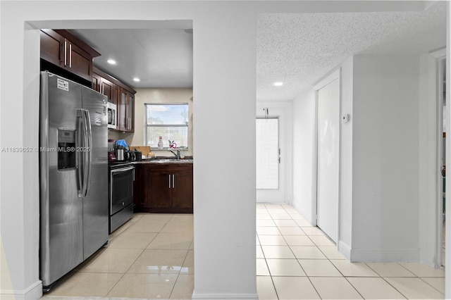 6600 Royal Palm Blvd Unit 103B, Margate, FL 33063 - kitchen with stainless steel appliances, light tile patterned floors, recessed lighting, dark brown cabinetry, and a textured ceiling