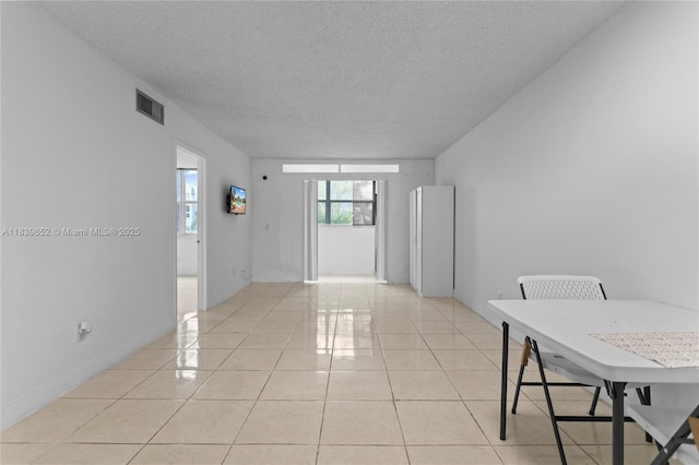 6600 Royal Palm Blvd Unit 103B, Margate, FL 33063 - empty room featuring a textured ceiling and light tile patterned floors