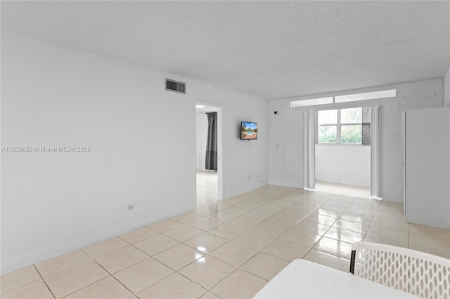 6600 Royal Palm Blvd Unit 103B, Margate, FL 33063 - empty room featuring light tile patterned floors and a textured ceiling