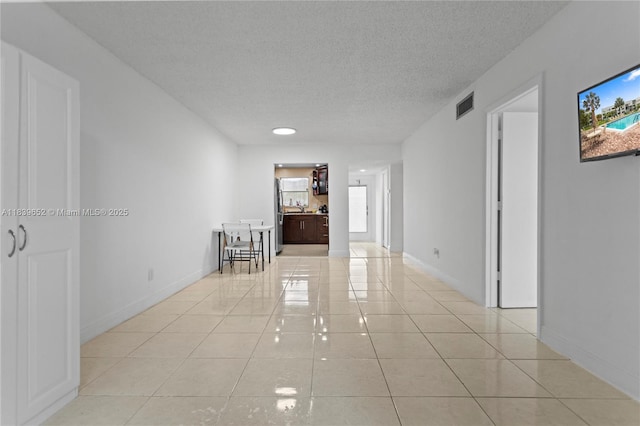 6600 Royal Palm Blvd Unit 103B, Margate, FL 33063 - empty room featuring light tile patterned floors, a textured ceiling, and healthy amount of natural light