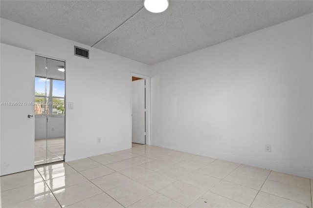 6600 Royal Palm Blvd Unit 103B, Margate, FL 33063 - unfurnished room featuring a textured ceiling and light tile patterned floors