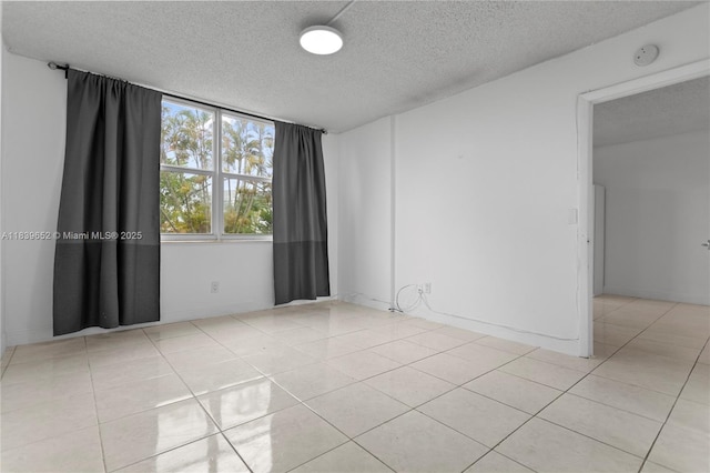 6600 Royal Palm Blvd Unit 103B, Margate, FL 33063 - spare room featuring a smoke detector, a textured ceiling, and light tile patterned flooring
