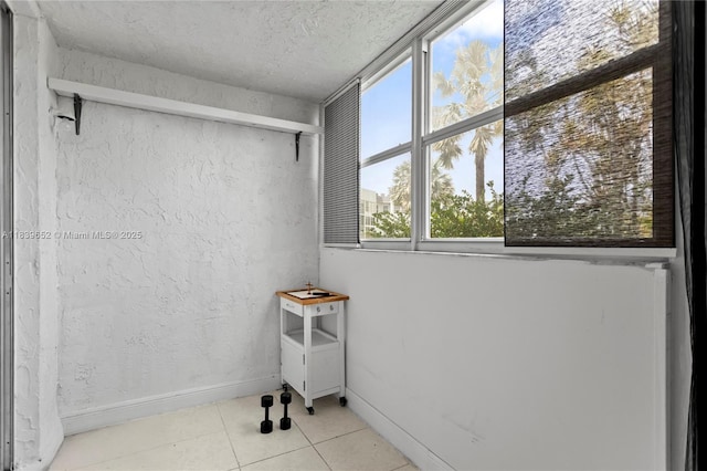 6600 Royal Palm Blvd Unit 103B, Margate, FL 33063 - tiled spare room featuring baseboards and a textured ceiling
