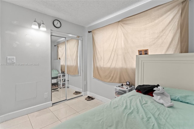 6600 Royal Palm Blvd Unit 103B, Margate, FL 33063 - bedroom featuring light tile patterned floors, a closet, and a textured ceiling
