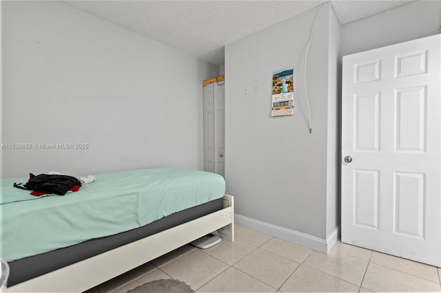 6600 Royal Palm Blvd Unit 103B, Margate, FL 33063 - bedroom with light tile patterned floors and a textured ceiling