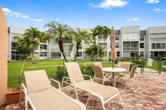 6600 Royal Palm Blvd Unit 103B, Margate, FL 33063 - view of patio with outdoor dining space, a gate, and a residential view