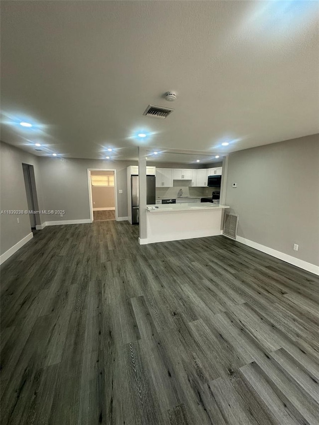 6990 SW 28th St, Miramar, FL 33023 - unfurnished living room with baseboards and dark wood-type flooring