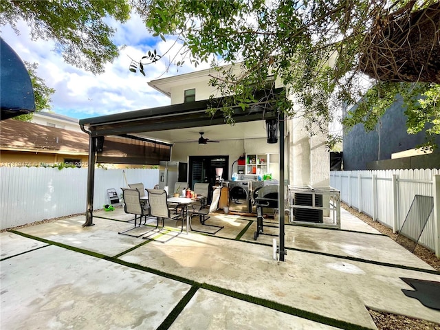 2957 NW 45th St, Miami, FL 33142 - rear view of property featuring outdoor dining space, ceiling fan, a patio, and a fenced backyard