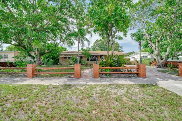 7140 Fillmore St, Hollywood, FL 33024 - ranch-style house with a fenced front yard and concrete driveway