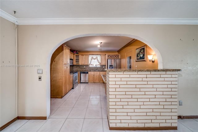 7140 Fillmore St, Hollywood, FL 33024 - kitchen featuring appliances with stainless steel finishes, ornamental molding, a peninsula, decorative backsplash, and arched walkways