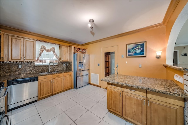 7140 Fillmore St, Hollywood, FL 33024 - kitchen with appliances with stainless steel finishes, ornamental molding, decorative backsplash, dark stone countertops, and arched walkways