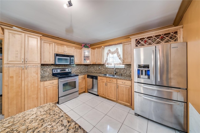 7140 Fillmore St, Hollywood, FL 33024 - kitchen with stainless steel appliances, backsplash, dark stone counters, light tile patterned floors, and light brown cabinets