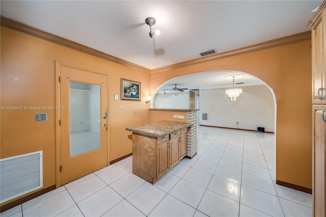 7140 Fillmore St, Hollywood, FL 33024 - kitchen with crown molding, arched walkways, ceiling fan, light tile patterned flooring, and light stone countertops