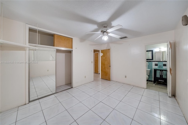 7140 Fillmore St, Hollywood, FL 33024 - unfurnished bedroom with a closet, light tile patterned flooring, ceiling fan, and connected bathroom