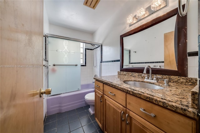 7140 Fillmore St, Hollywood, FL 33024 - full bath with tile patterned floors, vanity, shower / bath combination with glass door, and tile walls