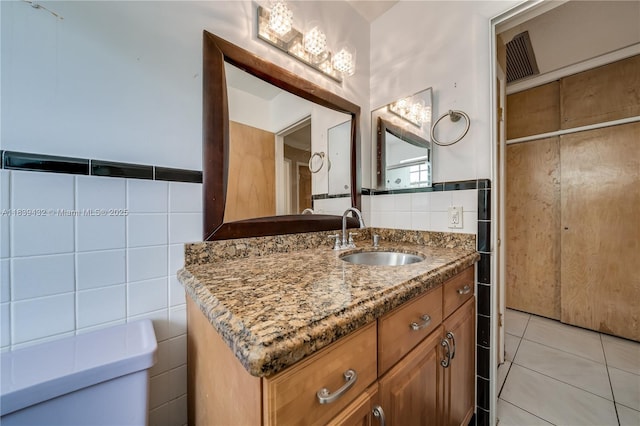 7140 Fillmore St, Hollywood, FL 33024 - bathroom featuring tile walls, vanity, tile patterned flooring, and a wainscoted wall