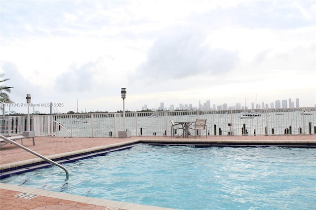 1228 W Ave Unit 911, Miami Beach, FL 33139 - community pool featuring a patio area and a skyline view