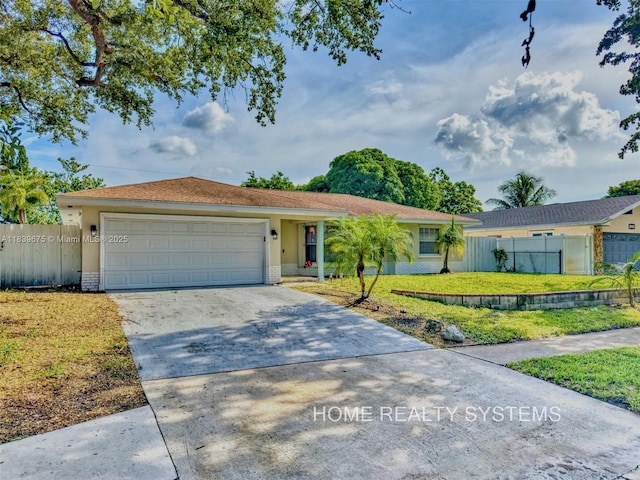 2359 Gabriel Ln, West Palm Beach, FL 33406 - ranch-style home featuring driveway, a garage, and stucco siding