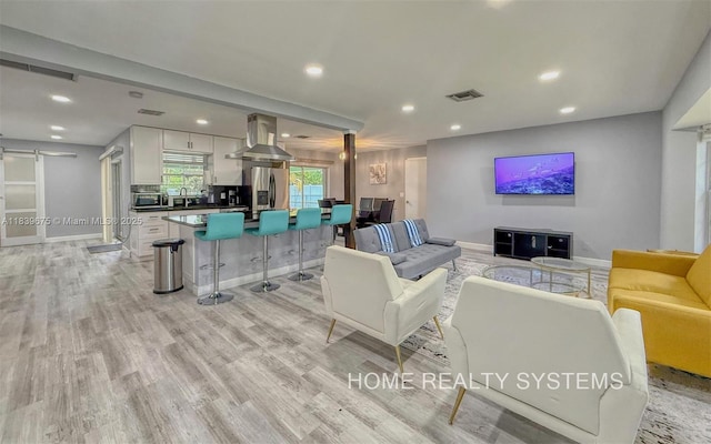 2359 Gabriel Ln, West Palm Beach, FL 33406 - living area featuring recessed lighting, light wood-type flooring, and a barn door