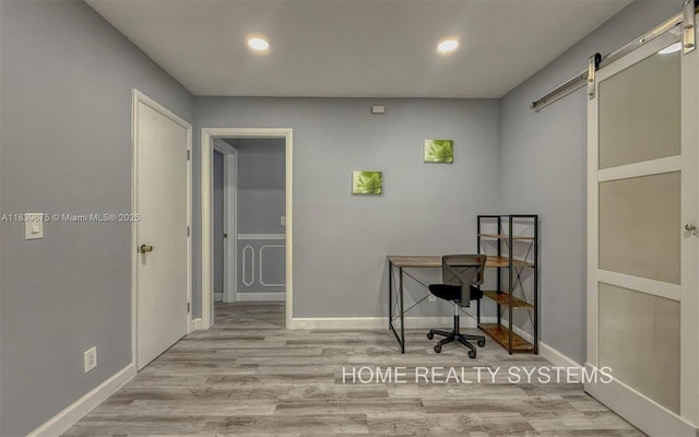 2359 Gabriel Ln, West Palm Beach, FL 33406 - home office featuring a barn door, recessed lighting, and wood finished floors