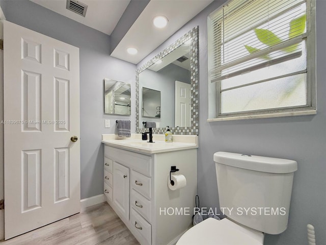 2359 Gabriel Ln, West Palm Beach, FL 33406 - bathroom with vanity, wood finished floors, and recessed lighting