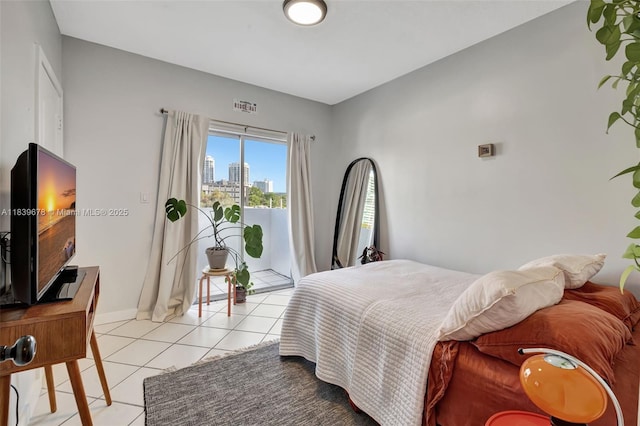 3051 SW 27th Ave Unit 402, Miami, FL 33133 - bedroom with access to exterior, light tile patterned floors, and a view of skyline
