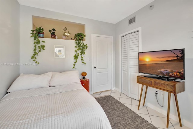 3051 SW 27th Ave Unit 402, Miami, FL 33133 - bedroom with light tile patterned floors and a closet