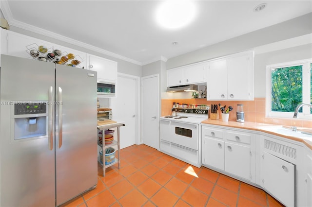 2665 SW 17th Ave, Miami, FL 33133 - kitchen with stainless steel fridge, white electric range, crown molding, under cabinet range hood, and white cabinets