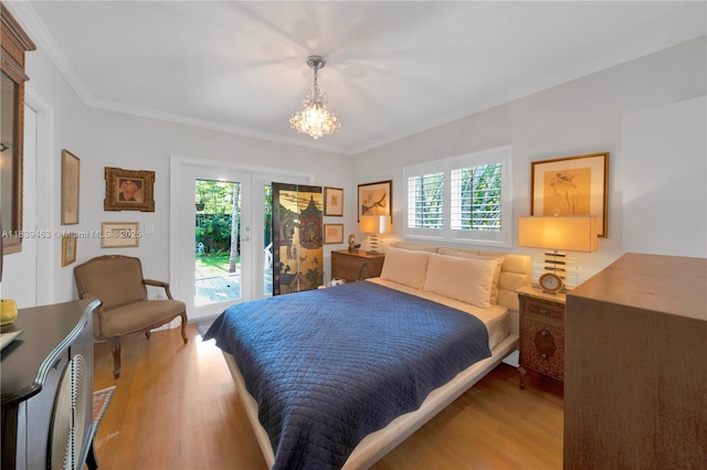 2665 SW 17th Ave, Miami, FL 33133 - bedroom featuring access to exterior, wood finished floors, a chandelier, and ornamental molding