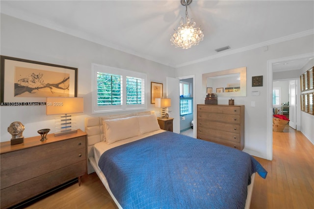 2665 SW 17th Ave, Miami, FL 33133 - bedroom featuring wood finished floors, a chandelier, and ornamental molding